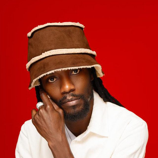 Zamunda portrait in a suede bucket hat on red