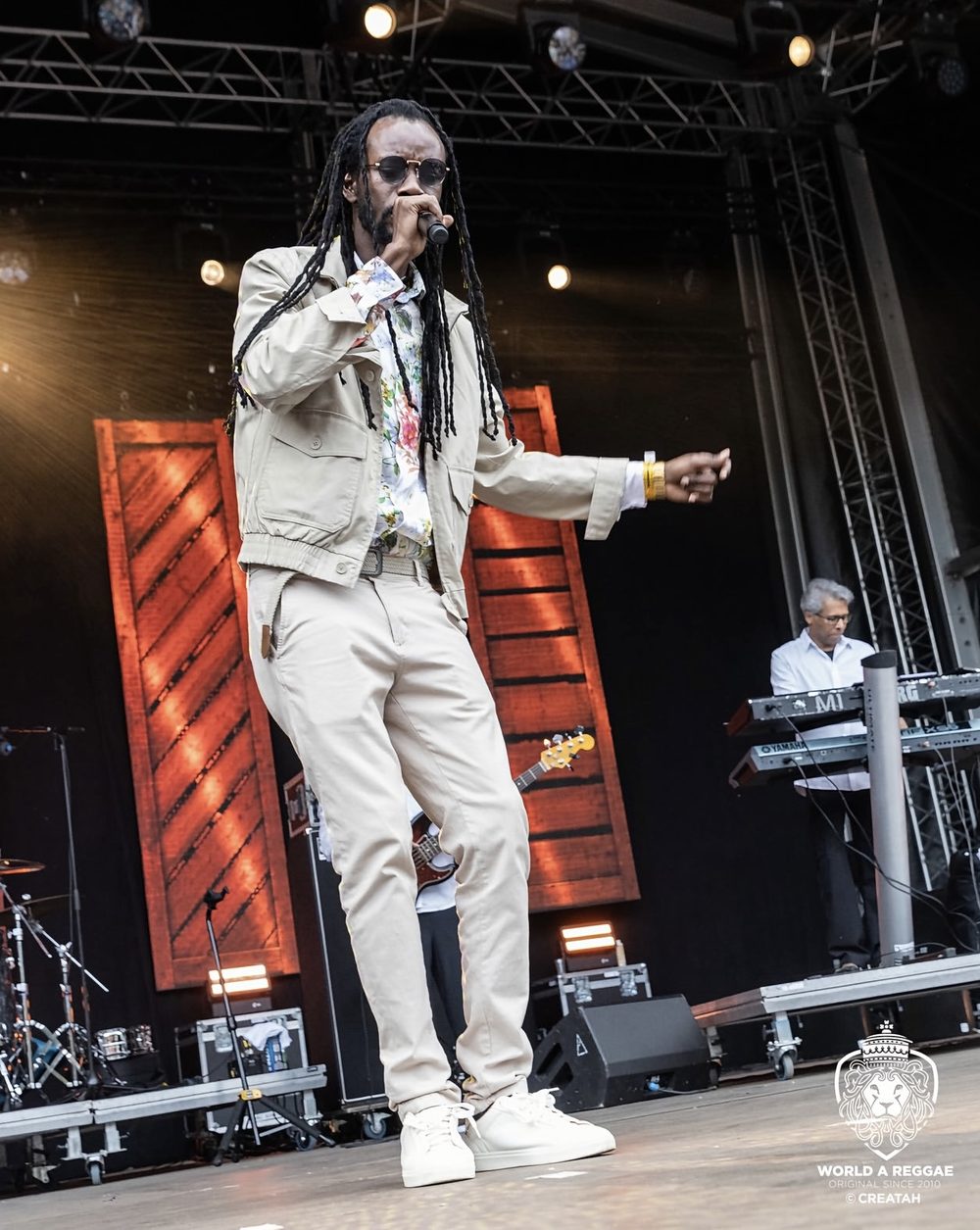 Zamunda performing on a festival stage with his band